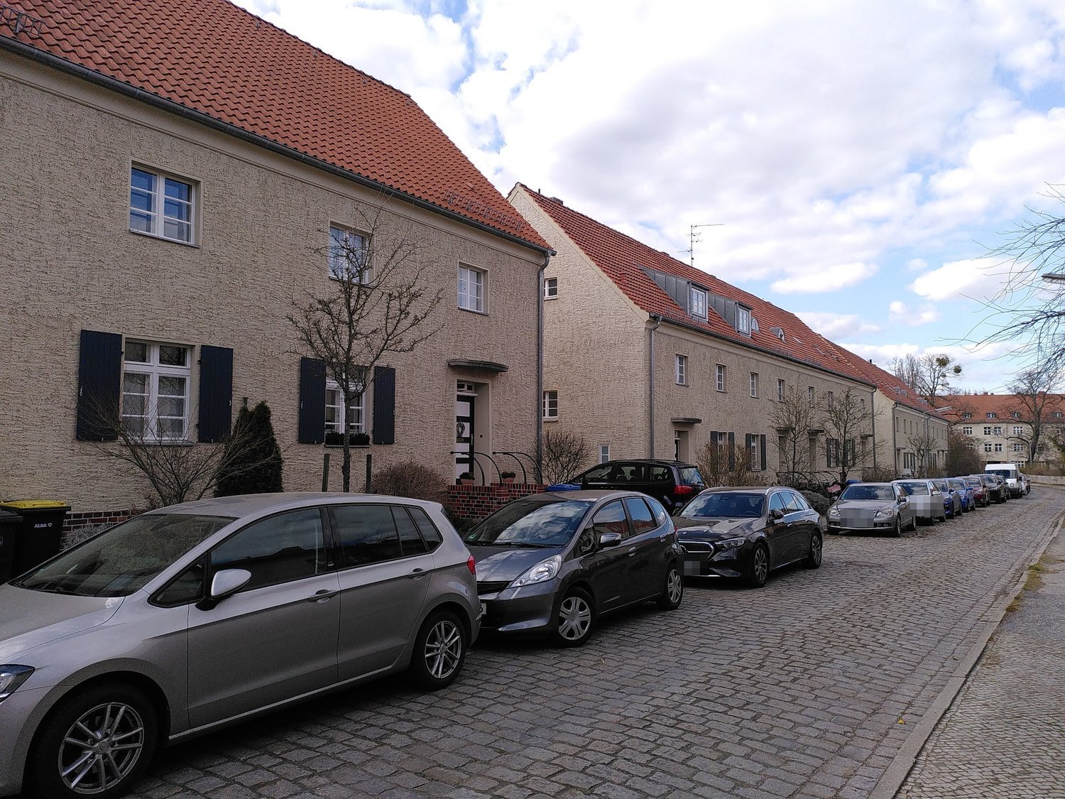 Häuserzeile mit dunkelblauen Fensterläden nach der Restaurierung