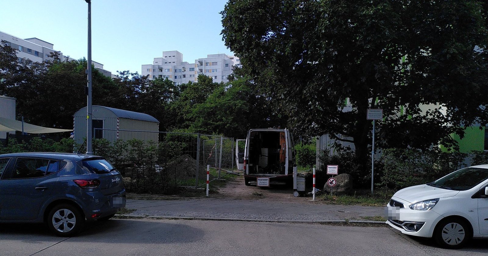 Fire department access with two removable bollards, sign and work van in Berlin-Rudow